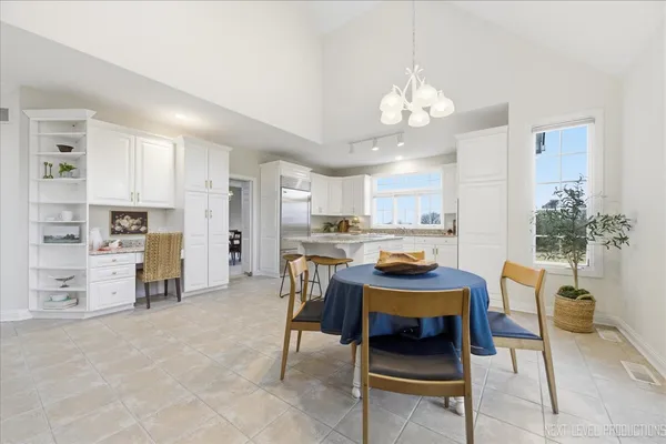 a living room with furniture a dining table and kitchen view