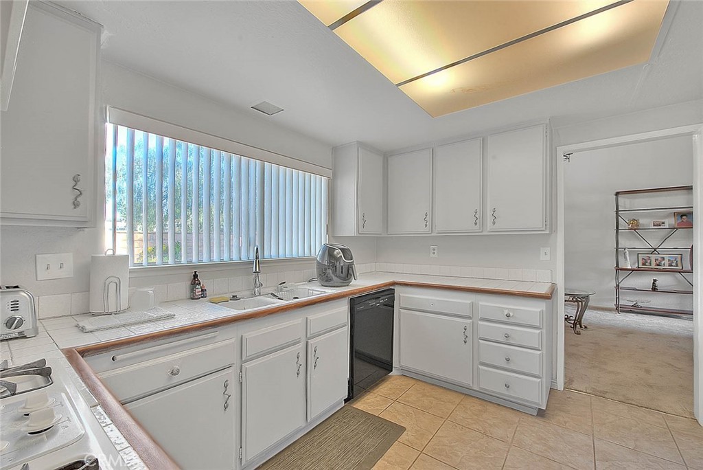8 Tanglewood Drive Phillips Ranch, CA 91766 - Photo 18 of 71 a kitchen with a sink window and cabinets