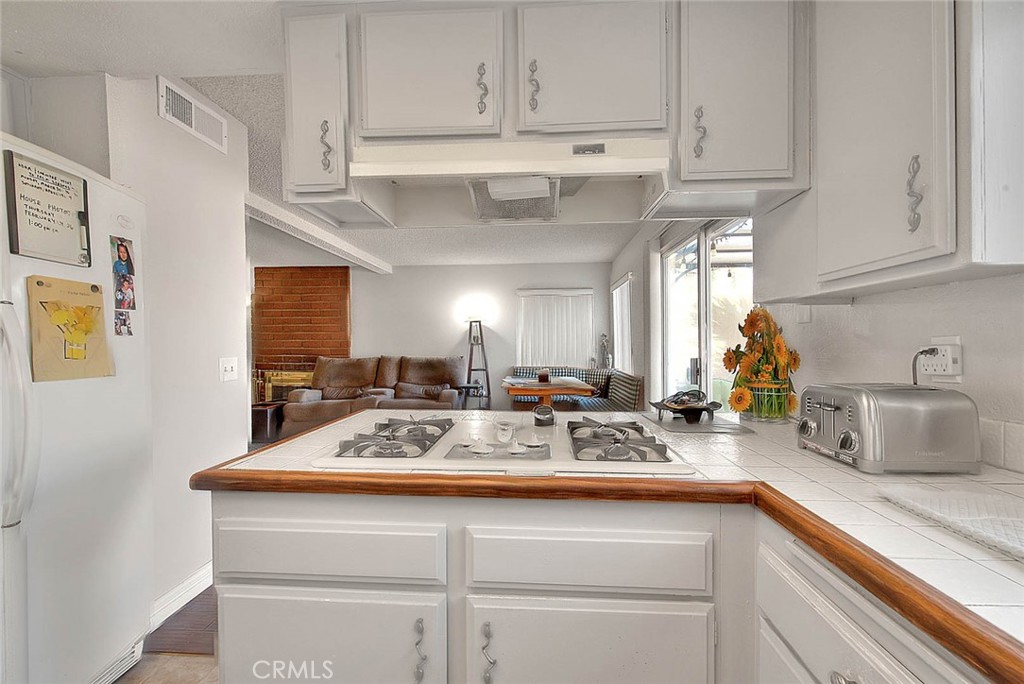 8 Tanglewood Drive Phillips Ranch, CA 91766 - Photo 21 of 71 a kitchen with stainless steel appliances granite countertop a sink a stove and cabinets