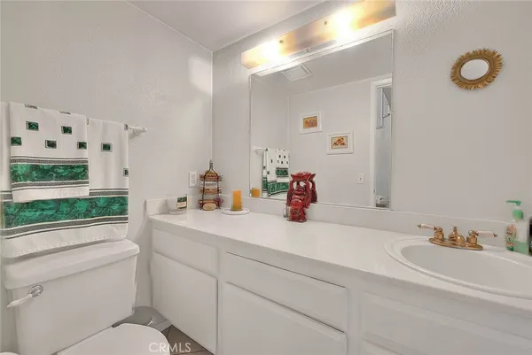 a bathroom with a sink vanity mirror and a shower