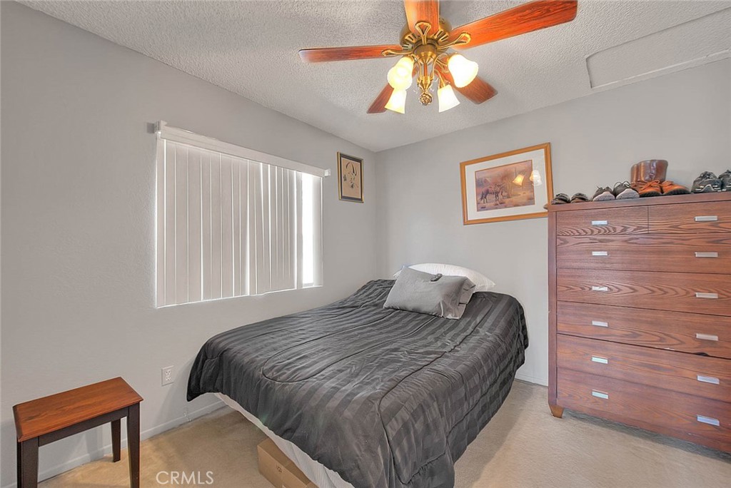 8 Tanglewood Drive Phillips Ranch, CA 91766 - Photo 32 of 71 a bedroom with a bed and a chandelier
