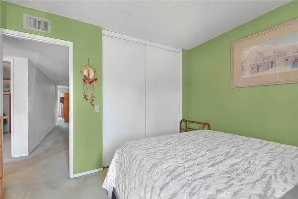 a large bed sitting in a bedroom next to a window