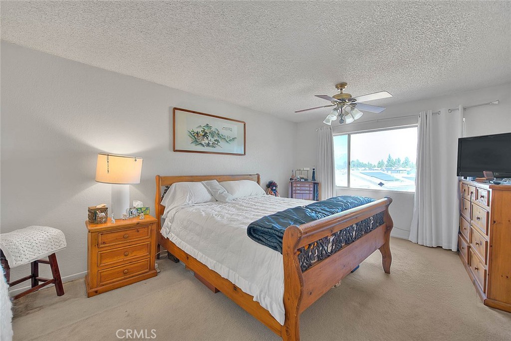 8 Tanglewood Drive Phillips Ranch, CA 91766 - Photo 38 of 71 a bedroom with a bed and a flat tv screen on dresser