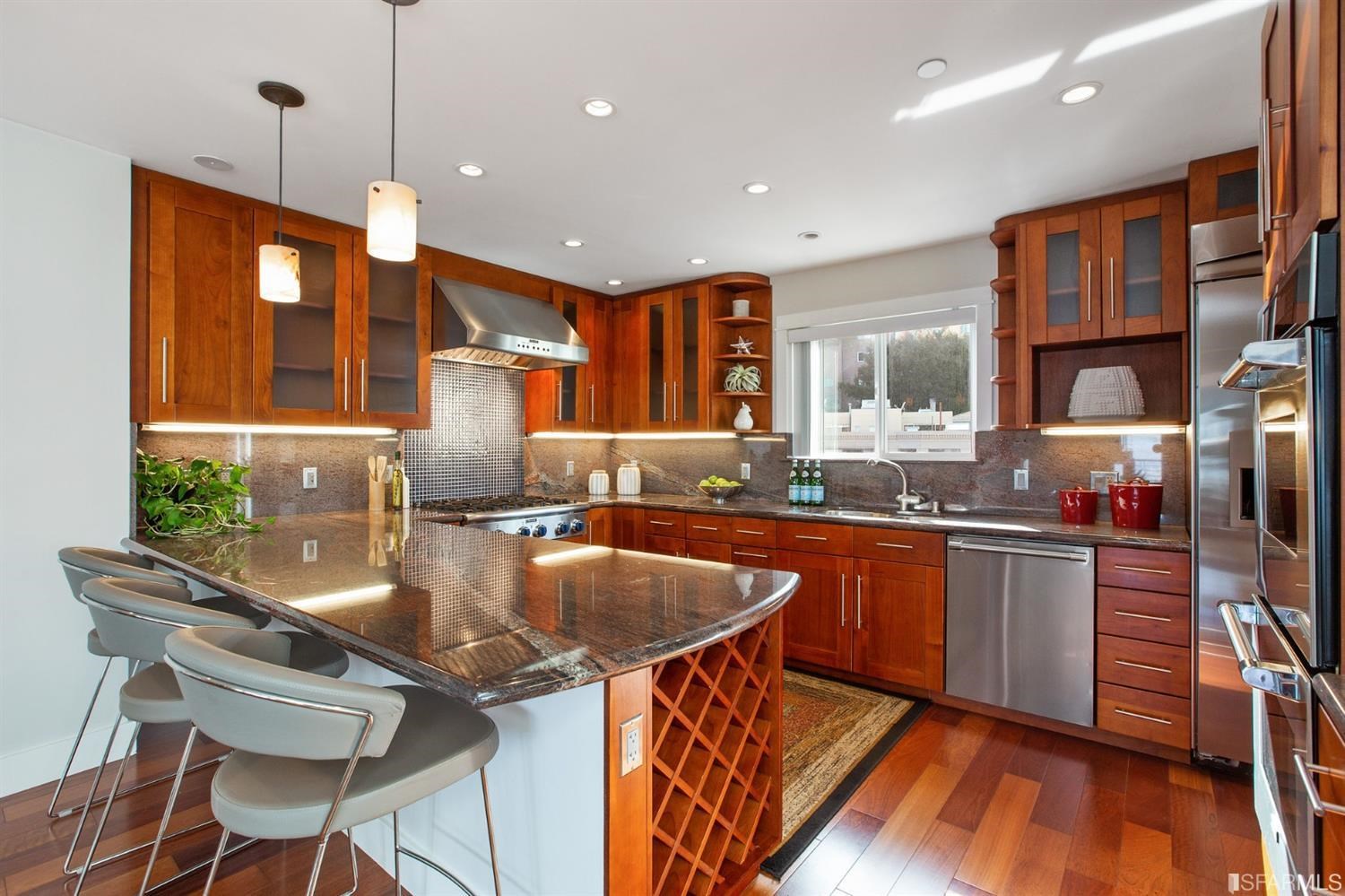 881 Corbett Avenue, Unit 3 San Francisco, CA 94131 - Photo 24 of 78 a kitchen with stainless steel appliances granite countertop a stove top oven a sink a dining table and chairs with wooden floor