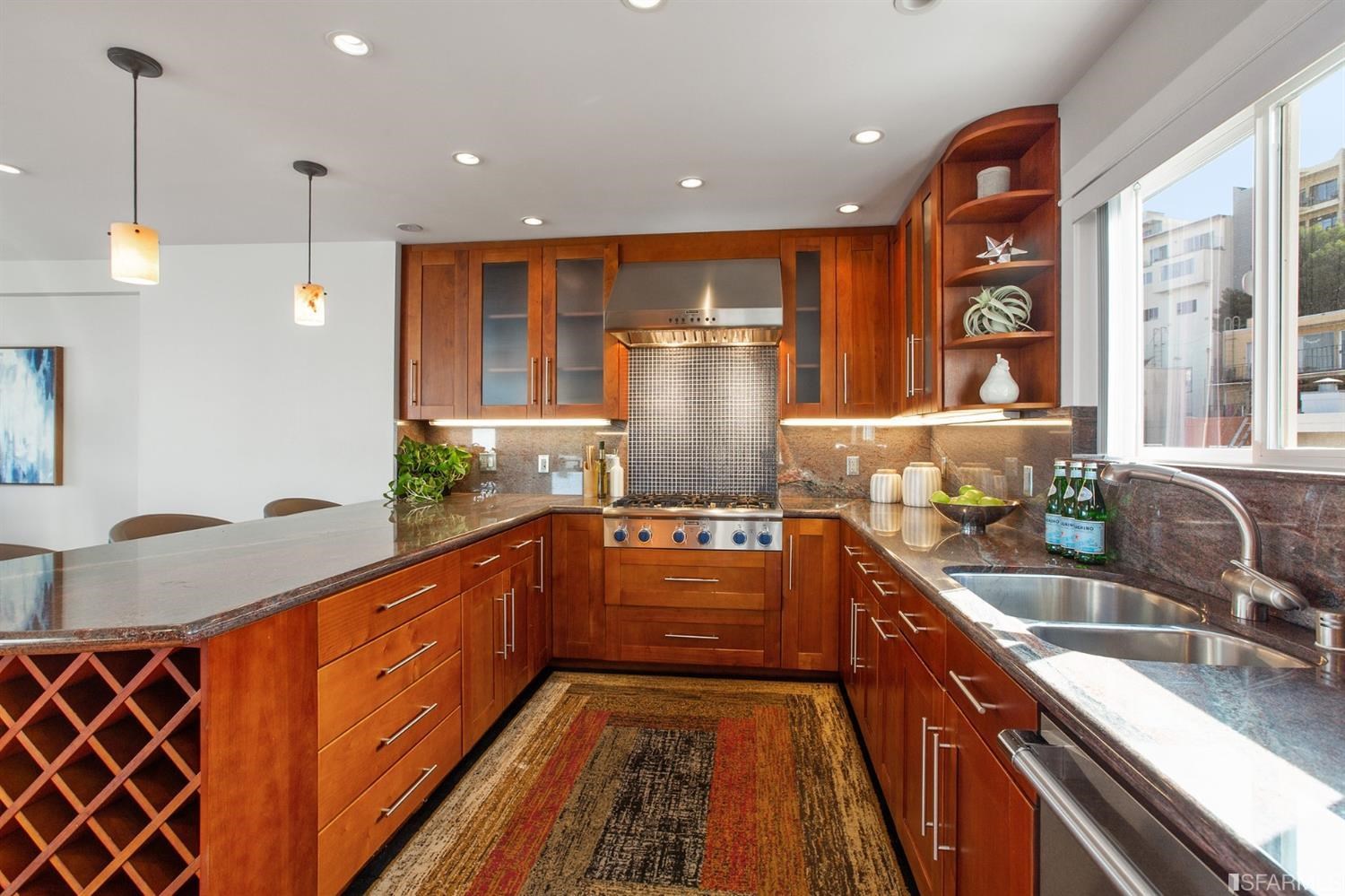 881 Corbett Avenue, Unit 3 San Francisco, CA 94131 - Photo 25 of 78 a kitchen with stainless steel appliances granite countertop a sink and wooden cabinets