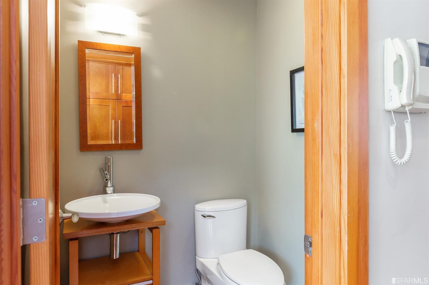 881 Corbett Avenue, Unit 3 San Francisco, CA 94131 - Photo 35 of 78 a bathroom with a toilet a sink and mirror