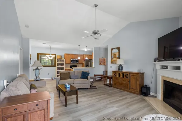 a view of a kitchen with stainless steel appliances granite countertop a stove and a refrigerator