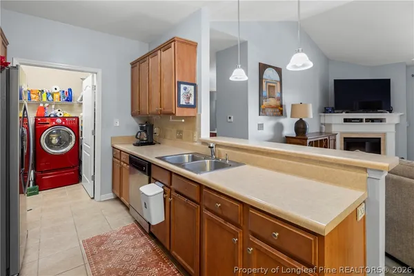 a kitchen with stainless steel appliances granite countertop a refrigerator a sink and a stove