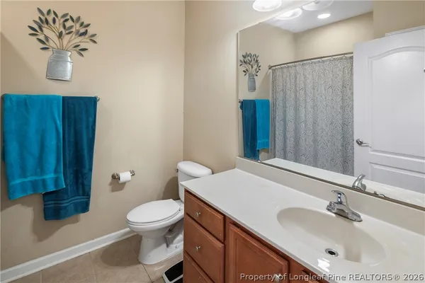 a bathroom with a shower curtain and a sink