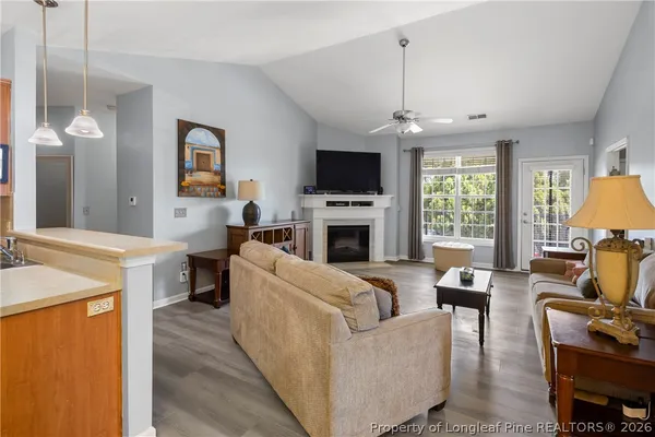 a living room with a fireplace and a flat screen tv