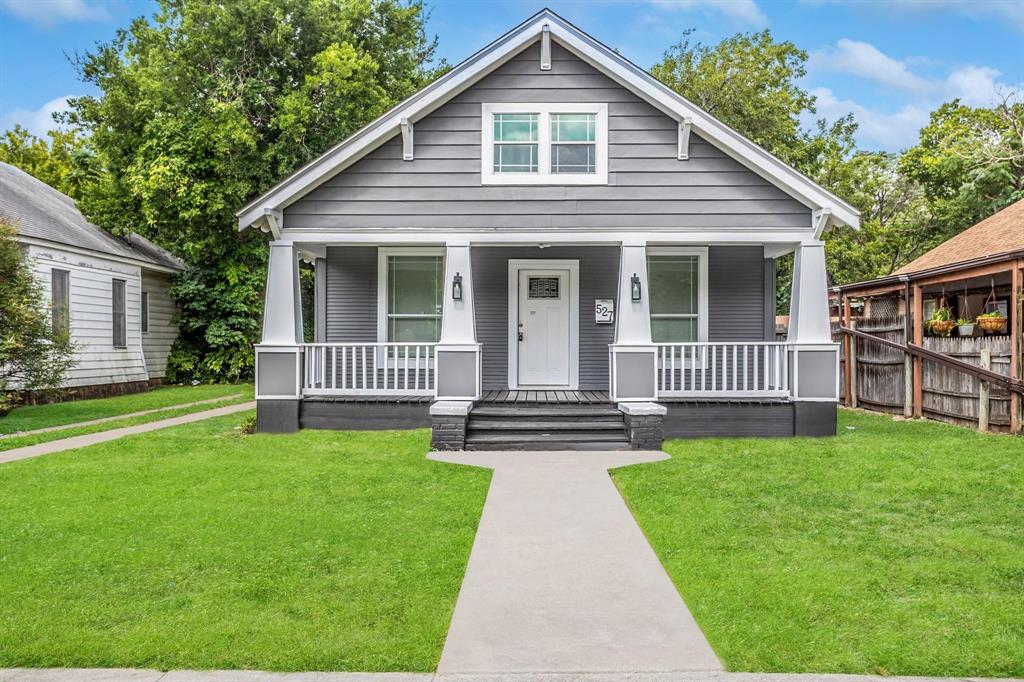a front view of a house with a yard table and chairs