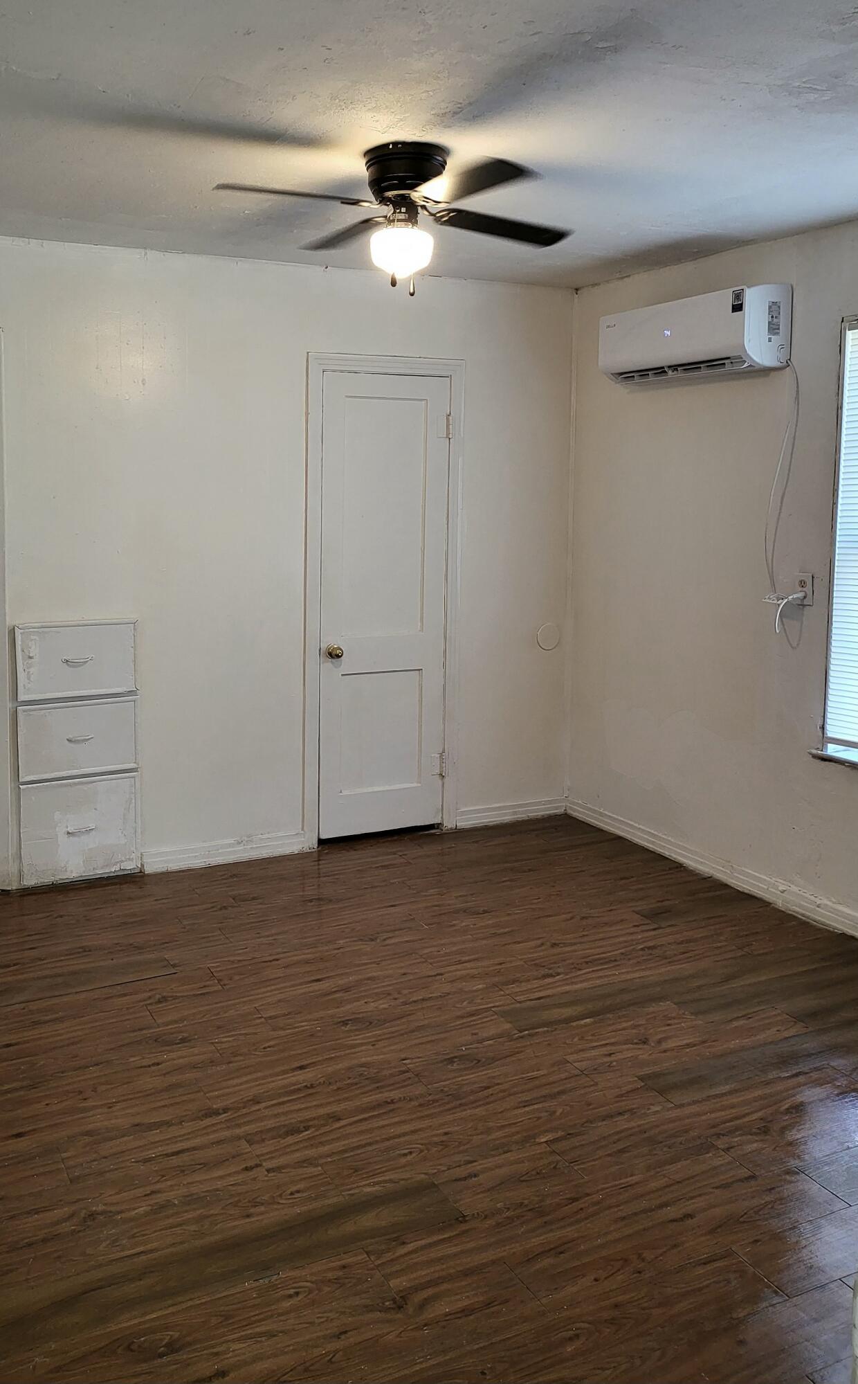 2824 Bates Street Lubbock, TX 79415 - Photo 11 of 19 a view of an empty room with wooden floor