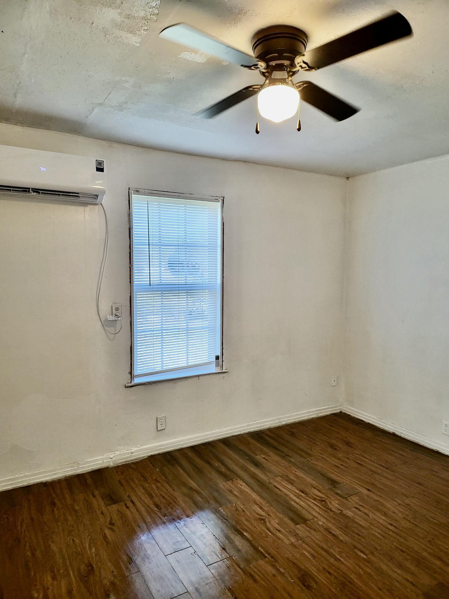 2824 Bates Street Lubbock, TX 79415 - Photo 12 of 19 a view of a room with wooden floor and a ceiling fan