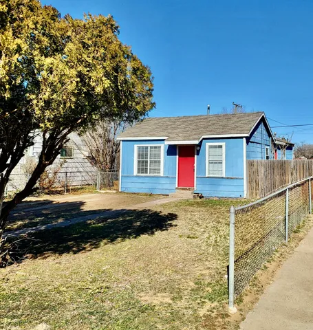 a view of a house with a yard covered with snow in the background