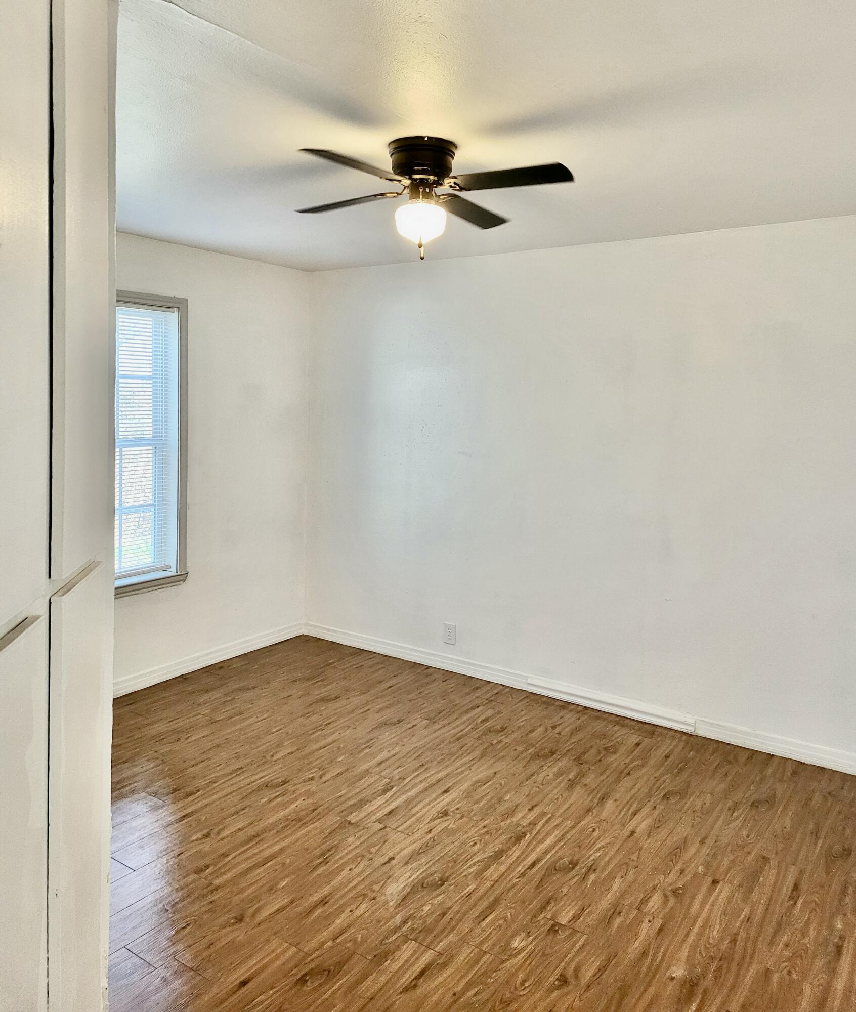 2824 Bates Street Lubbock, TX 79415 - Photo 8 of 19 a view of an empty room with wooden floor