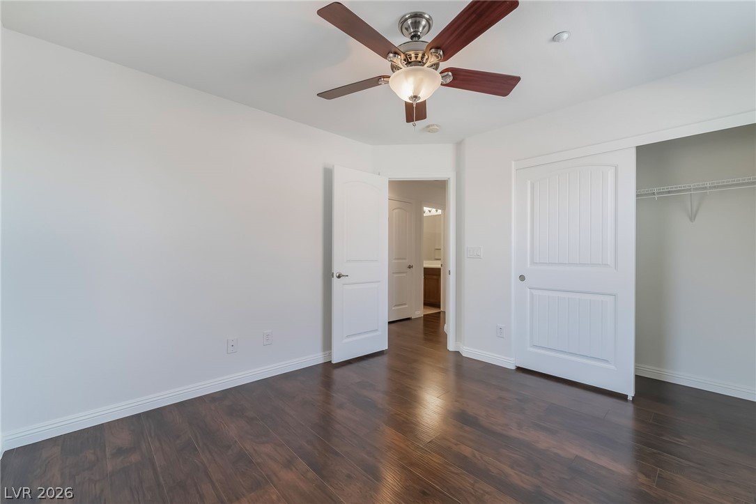 3175 Via Seranova Henderson, NV 89044 - Photo 33 of 45 This spacious bedroom offers rich hardwood flooring and a convenient closet, perfect for comfortable living.