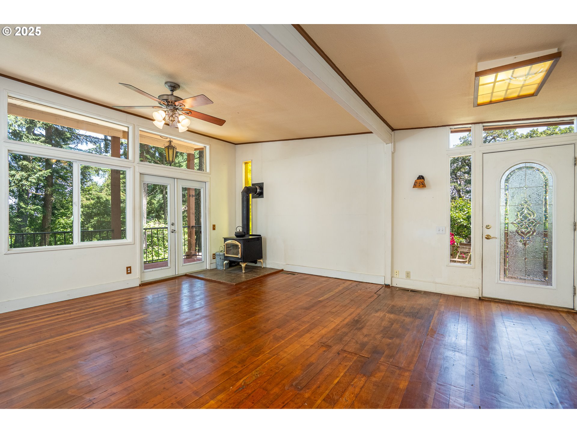 32468 Dillard Road Eugene, OR 97405 - Photo 3 of 28 a view of an empty room with a window and wooden floor