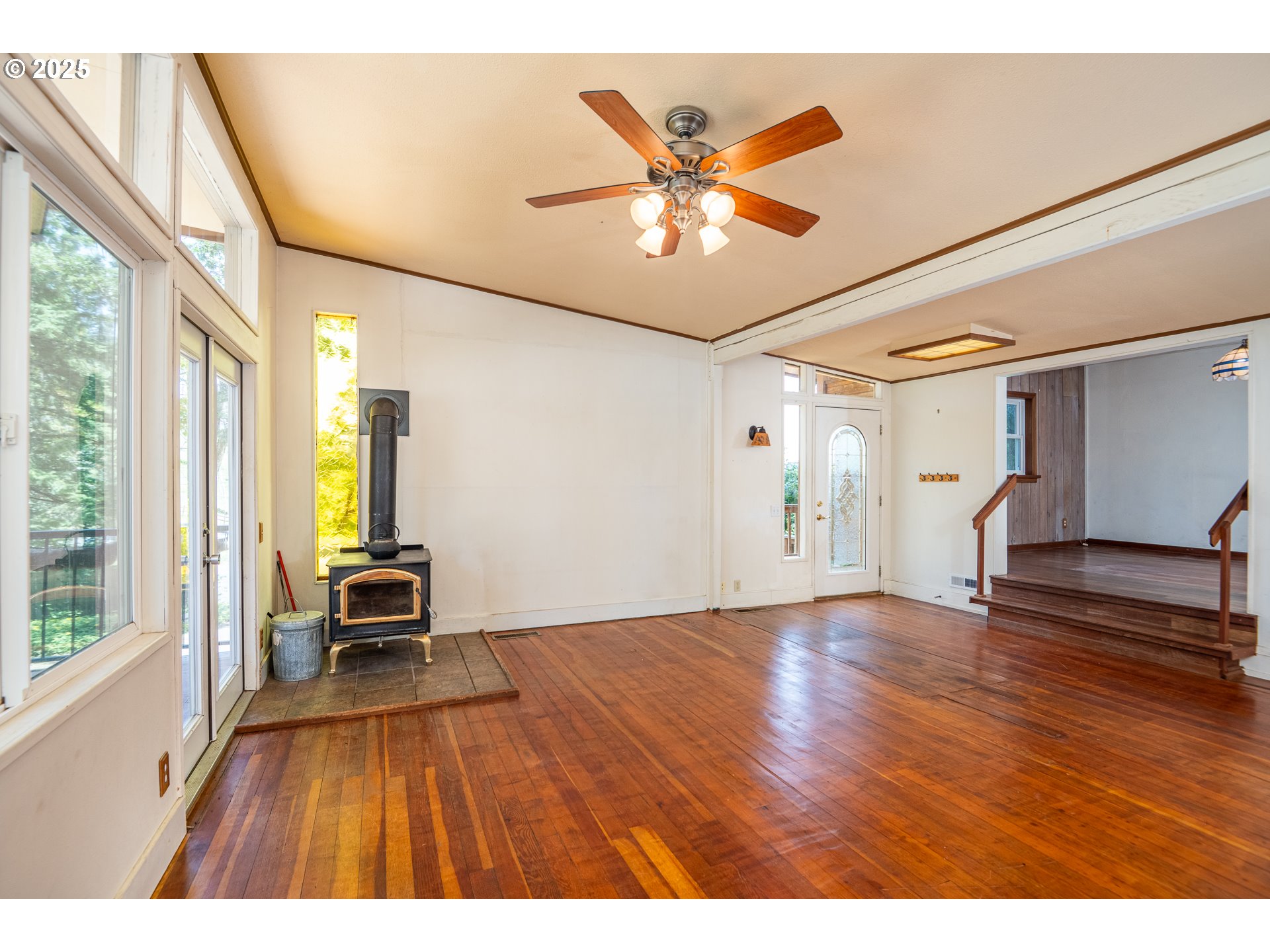 32468 Dillard Road Eugene, OR 97405 - Photo 4 of 28 a view of empty room with wooden floor and fan