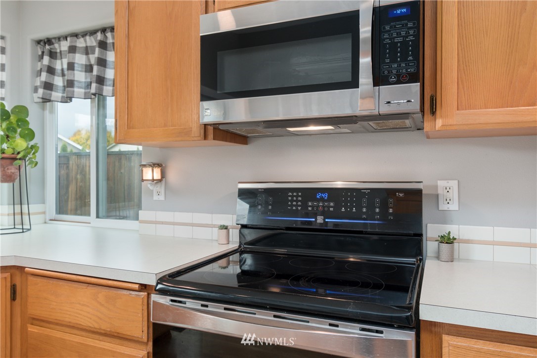 2111 Grove Street Longview, WA 98632 - Photo 11 of 26 a stove top oven sitting inside of a kitchen