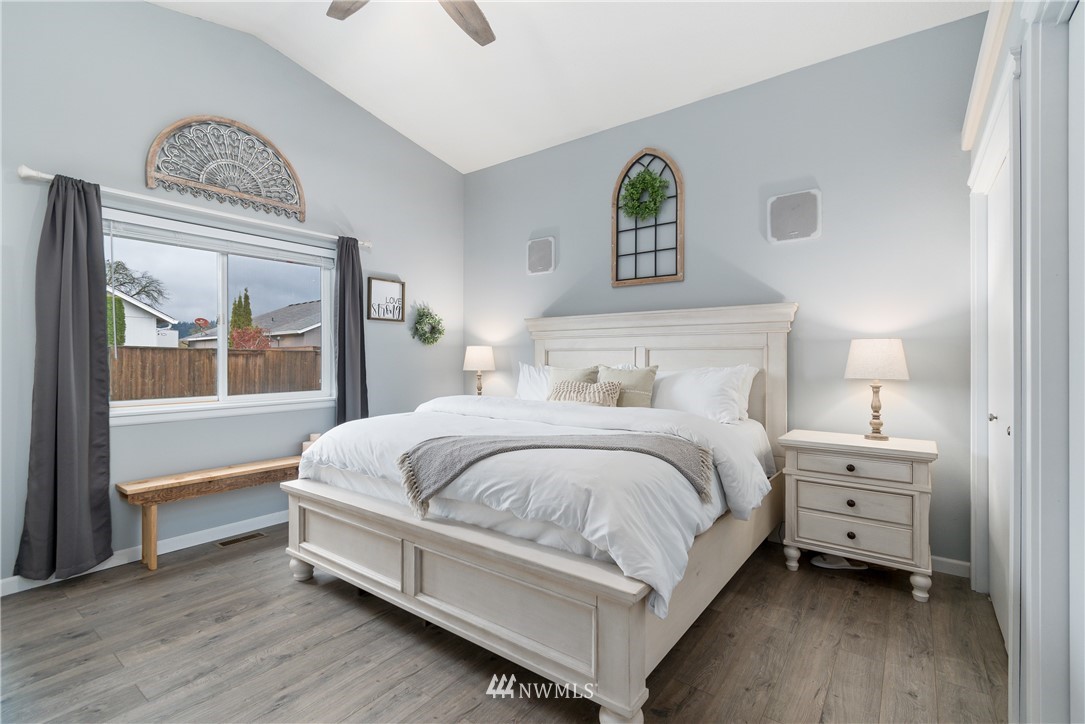 2111 Grove Street Longview, WA 98632 - Photo 13 of 26 a spacious bedroom with a bed table and a window