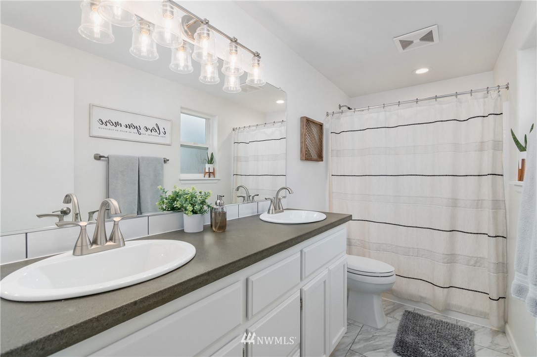 2111 Grove Street Longview, WA 98632 - Photo 14 of 26 a bathroom with a sink and a mirror