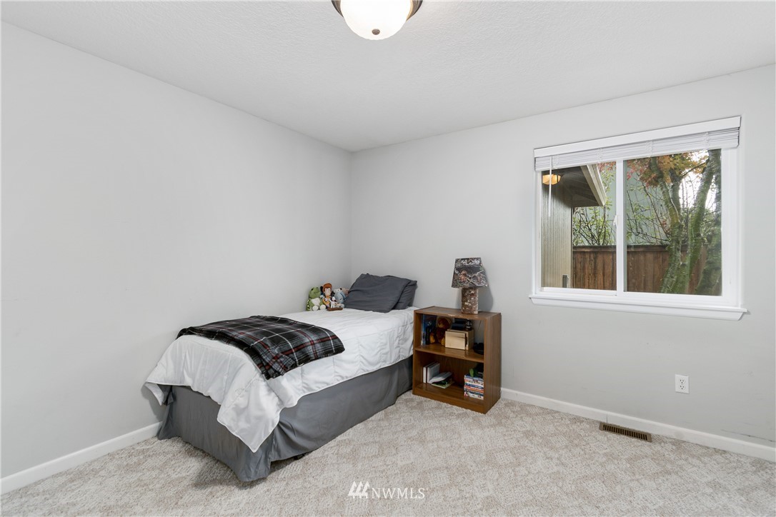 2111 Grove Street Longview, WA 98632 - Photo 18 of 26 a bedroom with a bed and a window