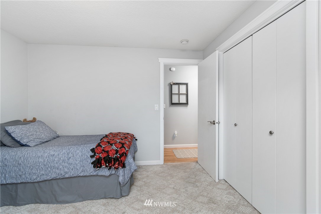 2111 Grove Street Longview, WA 98632 - Photo 21 of 26 a bedroom with a bed and a couch