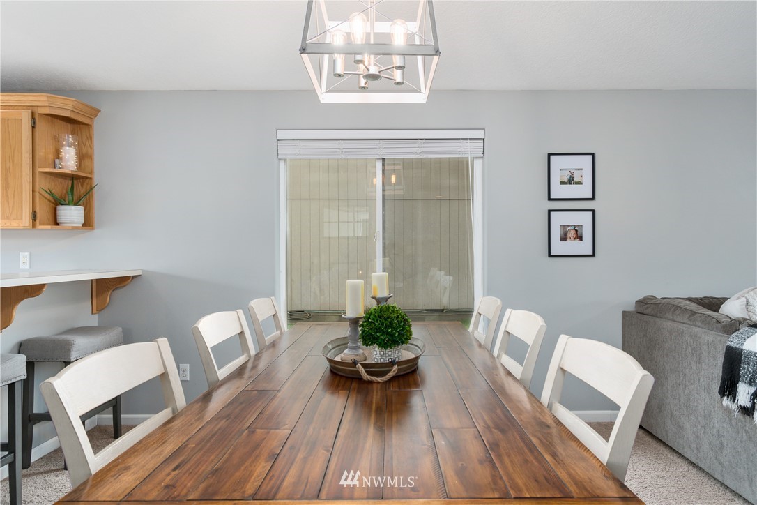 2111 Grove Street Longview, WA 98632 - Photo 8 of 26 a view of a dining room with furniture a chandelier and wooden floor