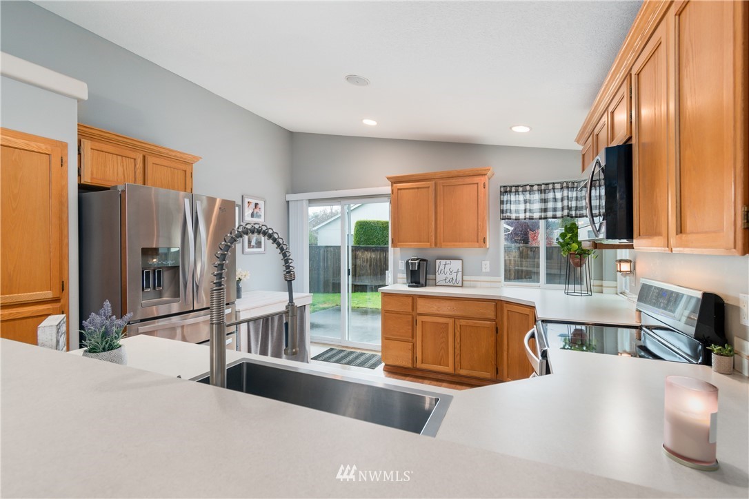 2111 Grove Street Longview, WA 98632 - Photo 10 of 26 a large kitchen with granite countertop a large window and stainless steel appliances