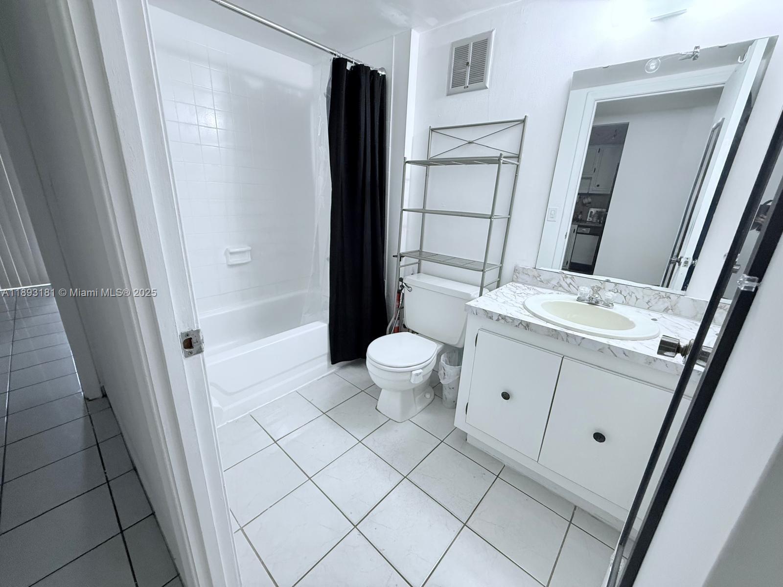 300 Northwest 42nd Avenue, Unit 109 Miami, FL 33126 - Photo 6 of 18 a bathroom with a sink a toilet a mirror and shower