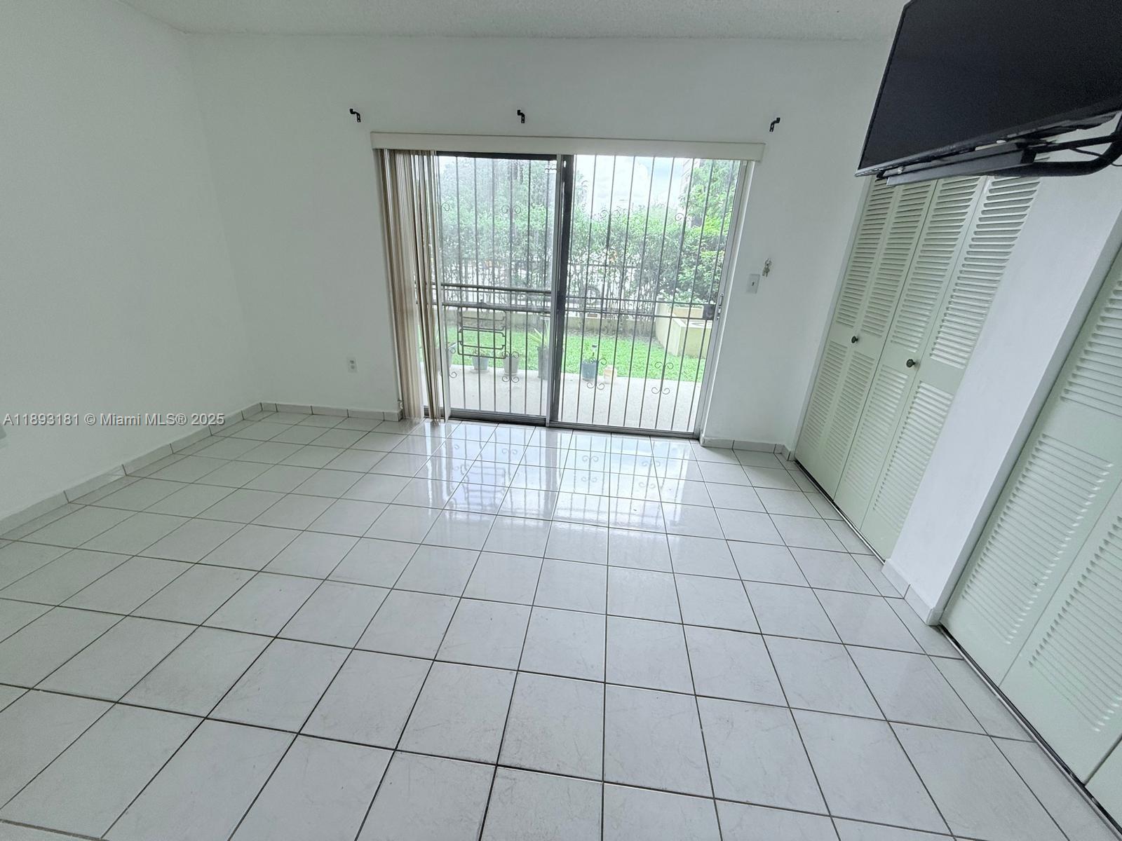 300 Northwest 42nd Avenue, Unit 109 Miami, FL 33126 - Photo 9 of 18 a view of an empty room and window