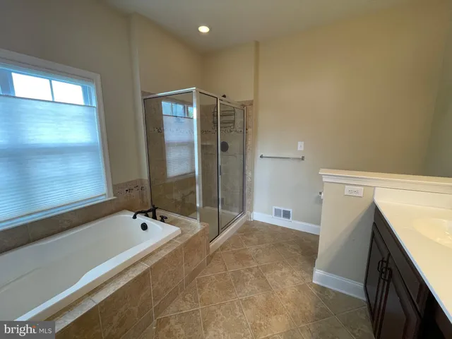 a bathroom with a bathtub and a sink