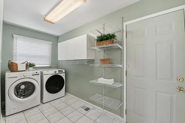a utility room with sink dryer and washer