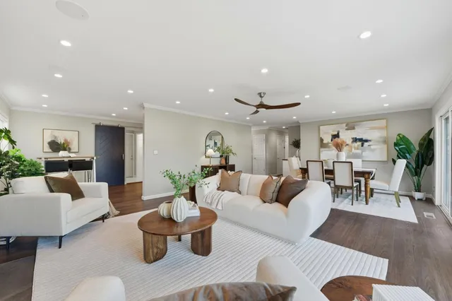 a living room with furniture and view of kitchen