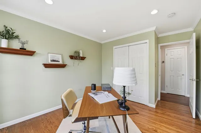a workspace room with furniture and wooden floor