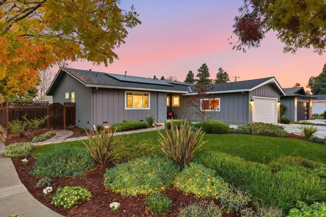 a view of a patio with a table chairs and a yard