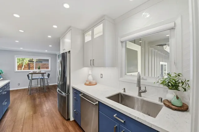 a kitchen with granite countertop a sink and wooden floor