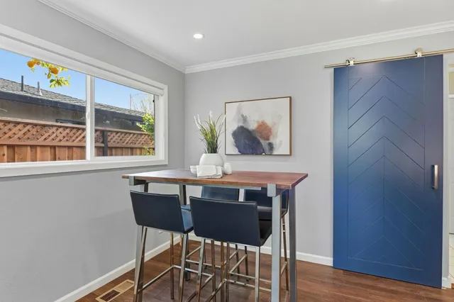 a view of a dining room with furniture a livingroom and wooden floor