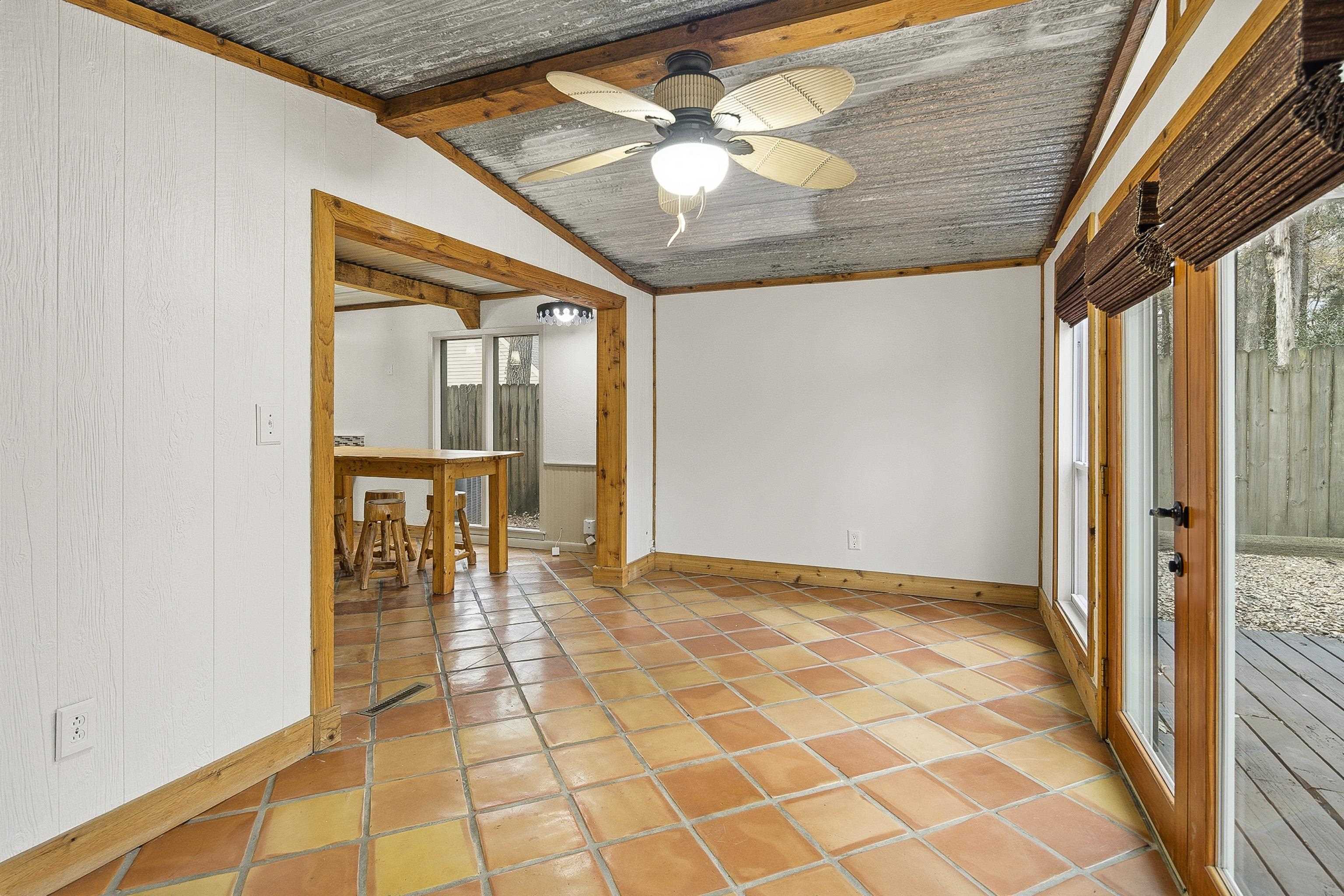 1833 New Riverdale Road Germantown, TN 38138 - Photo 18 of 40 a view of a hallway with a dining table and chandelier fan