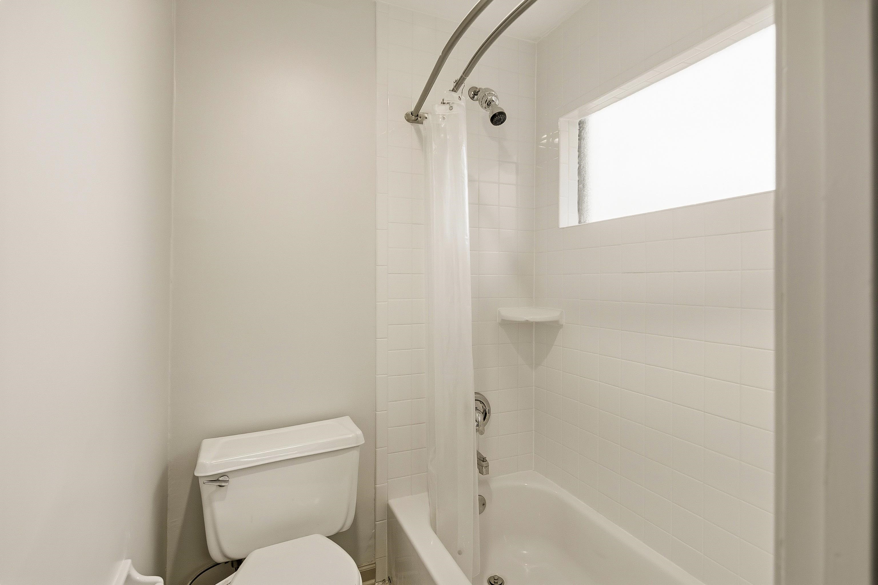 1833 New Riverdale Road Germantown, TN 38138 - Photo 30 of 40 a white toilet sitting next to a bath tub