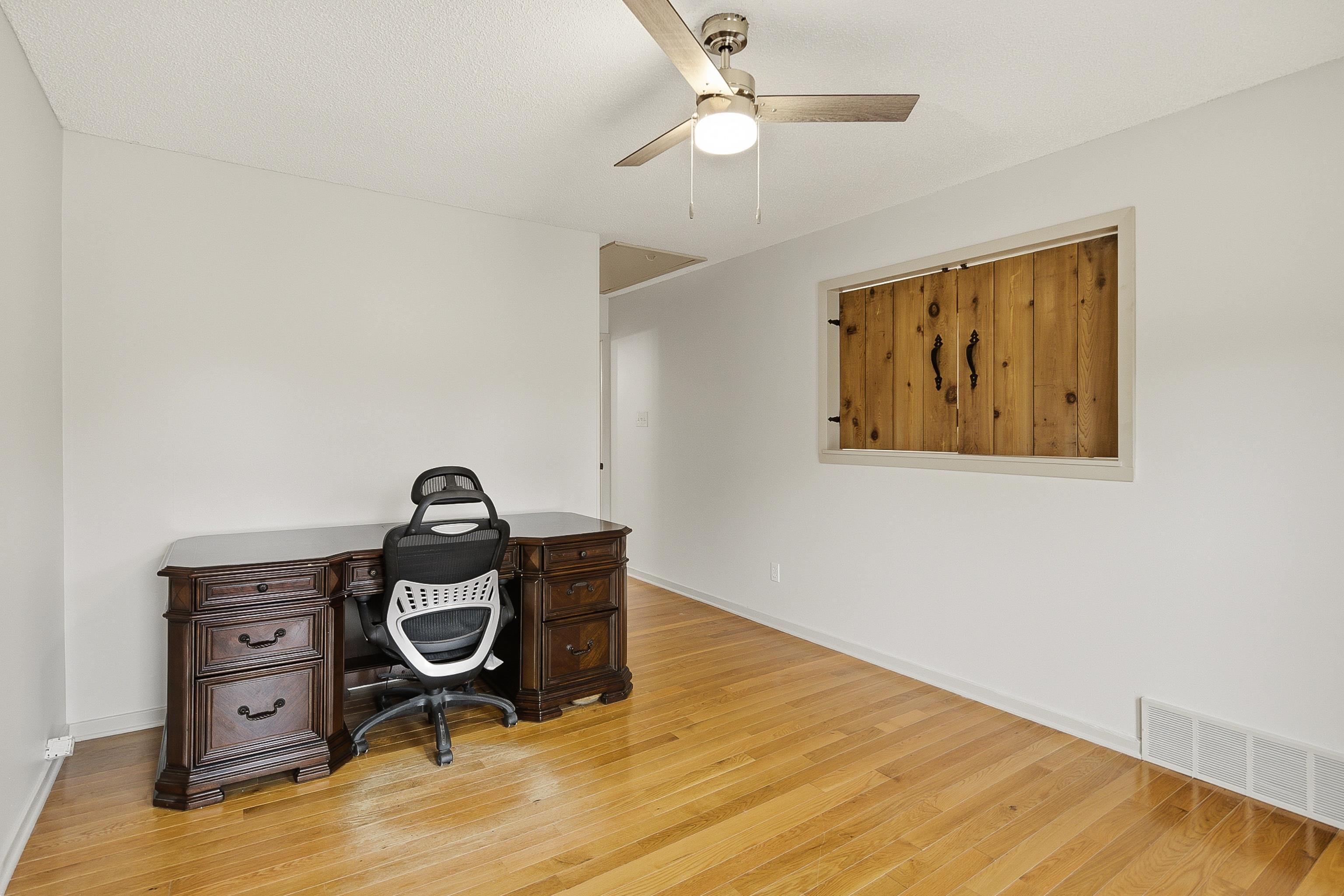 1833 New Riverdale Road Germantown, TN 38138 - Photo 32 of 40 a view of workspace with wooden floor and ceiling fan