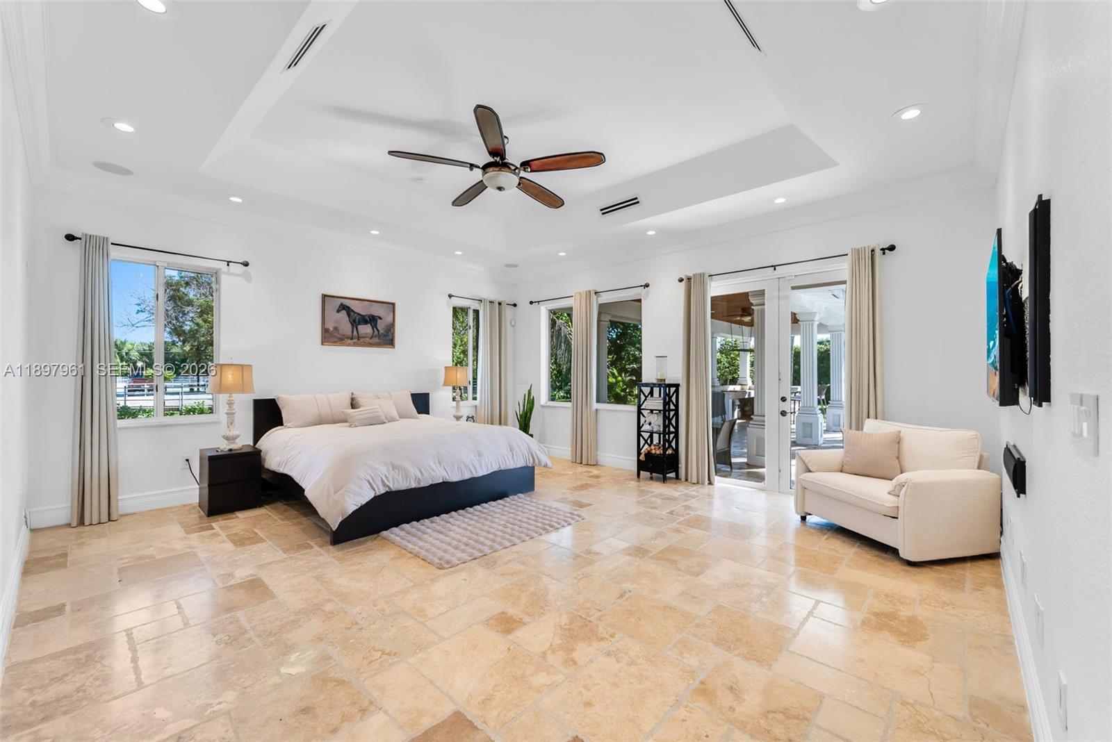 21331 Southwest 246th Street Homestead, FL 33031 - Photo 12 of 34 a spacious bedroom with a large bed and a couch