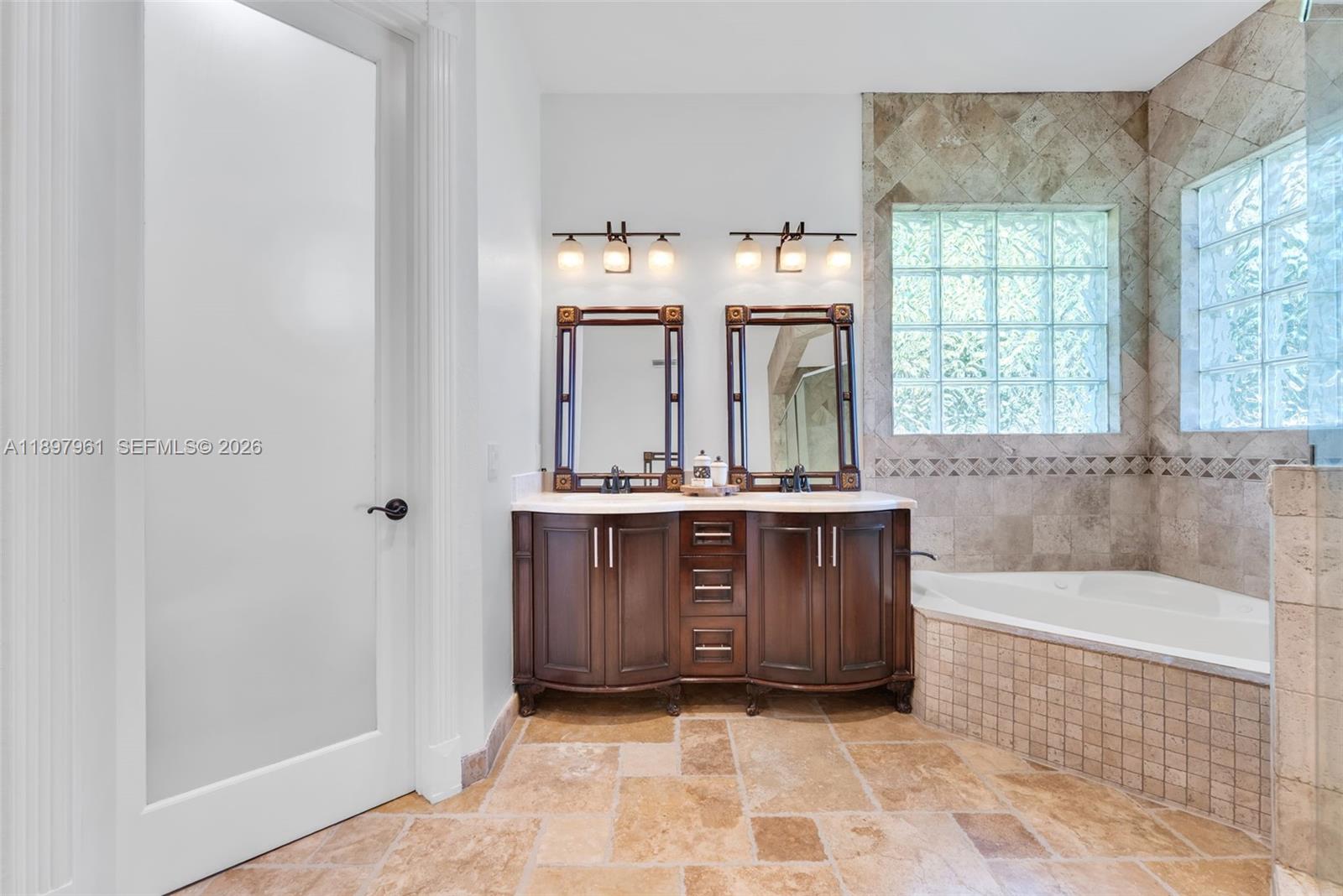 21331 Southwest 246th Street Homestead, FL 33031 - Photo 14 of 34 a bathroom with a tub sink and mirror