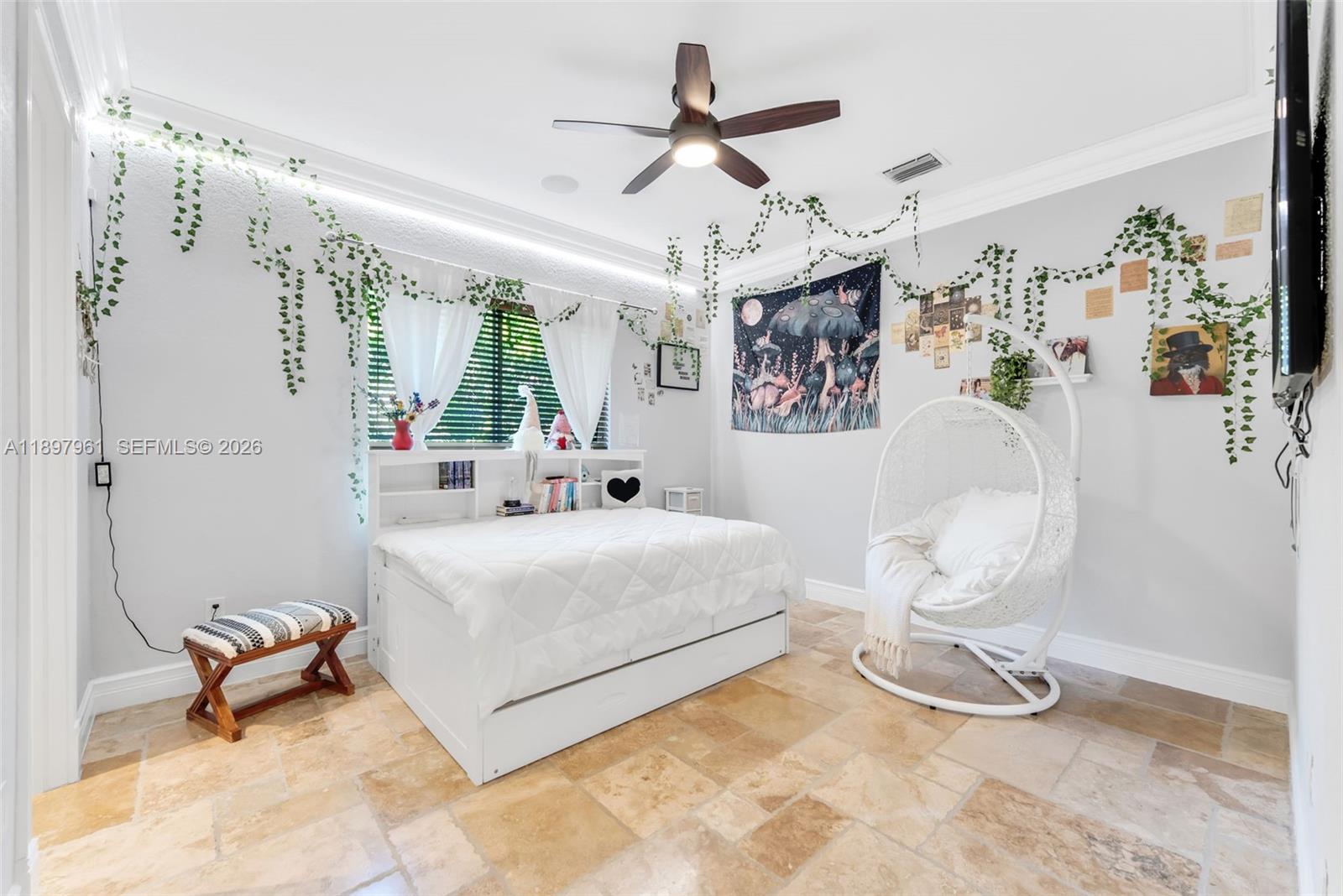 21331 Southwest 246th Street Homestead, FL 33031 - Photo 15 of 34 a white bed sitting in a bedroom next to a window and a chandelier