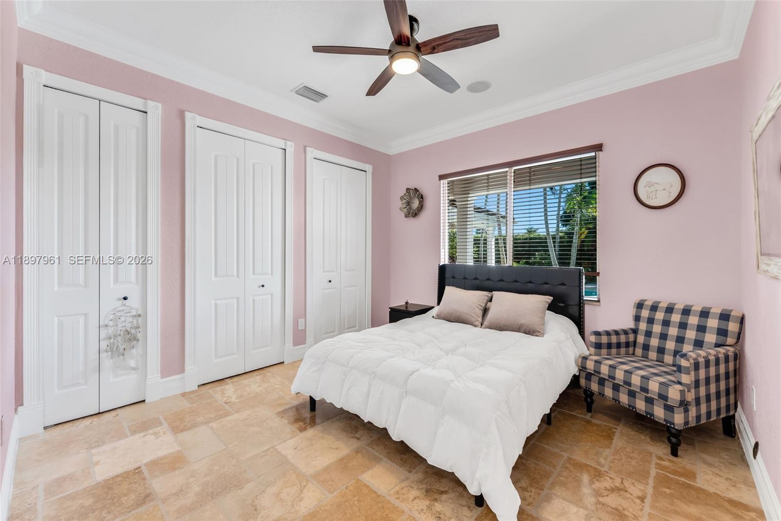 21331 Southwest 246th Street Homestead, FL 33031 - Photo 17 of 34 a bedroom with a bed and window