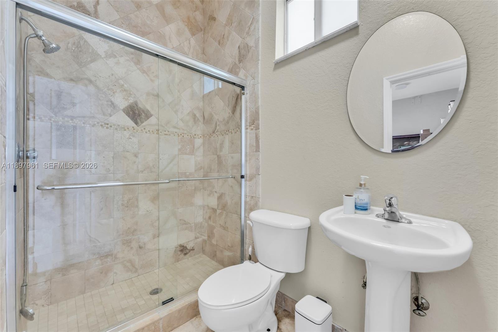 21331 Southwest 246th Street Homestead, FL 33031 - Photo 25 of 34 a bathroom with a toilet sink and a shower