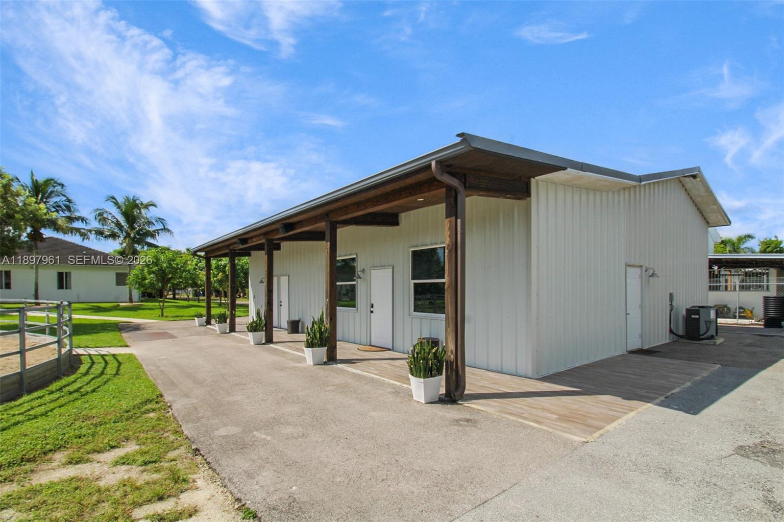 21331 Southwest 246th Street Homestead, FL 33031 - Photo 30 of 34 a view of a house with backyard and a tree