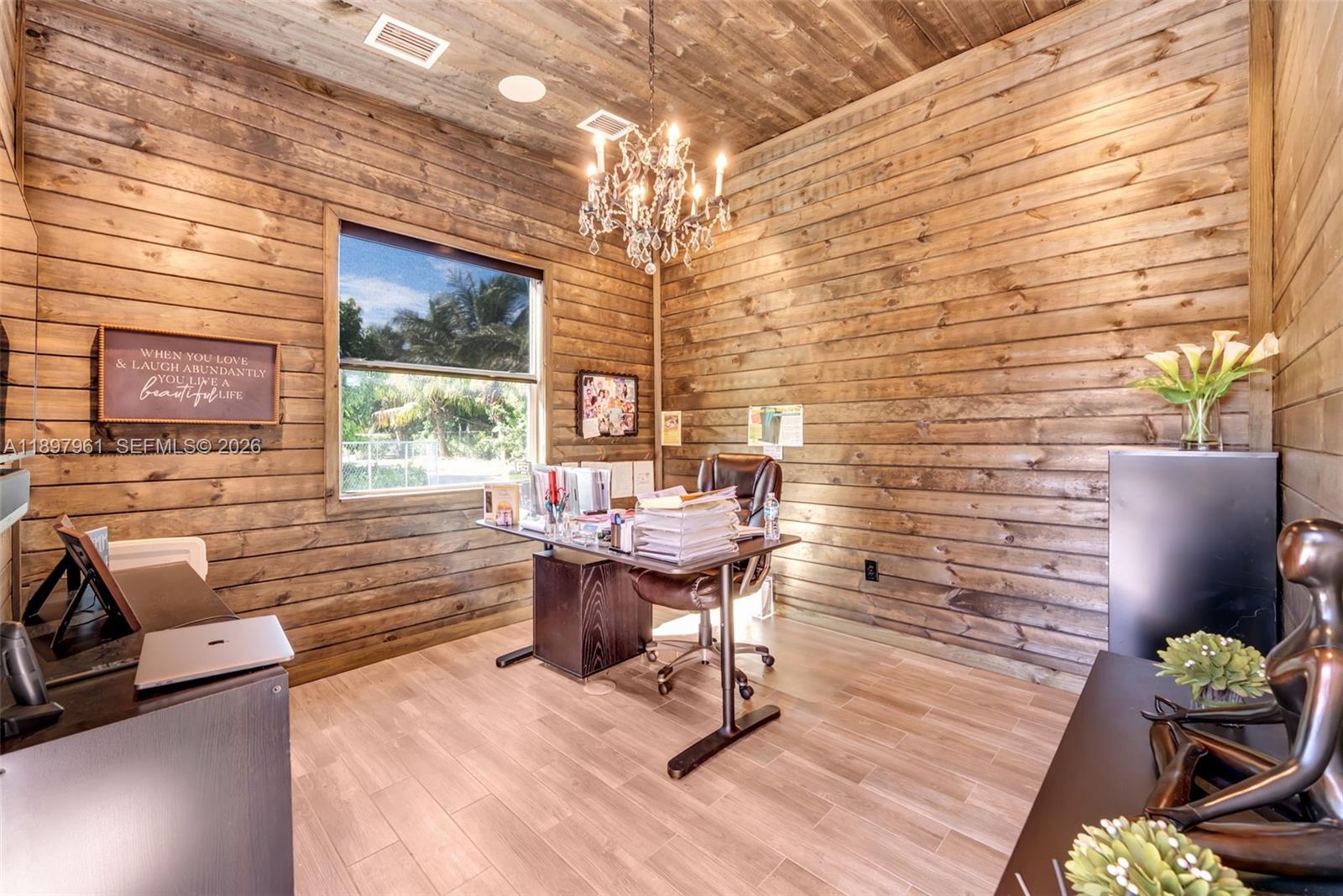 21331 Southwest 246th Street Homestead, FL 33031 - Photo 32 of 34 a view of a livingroom with workspace and a window