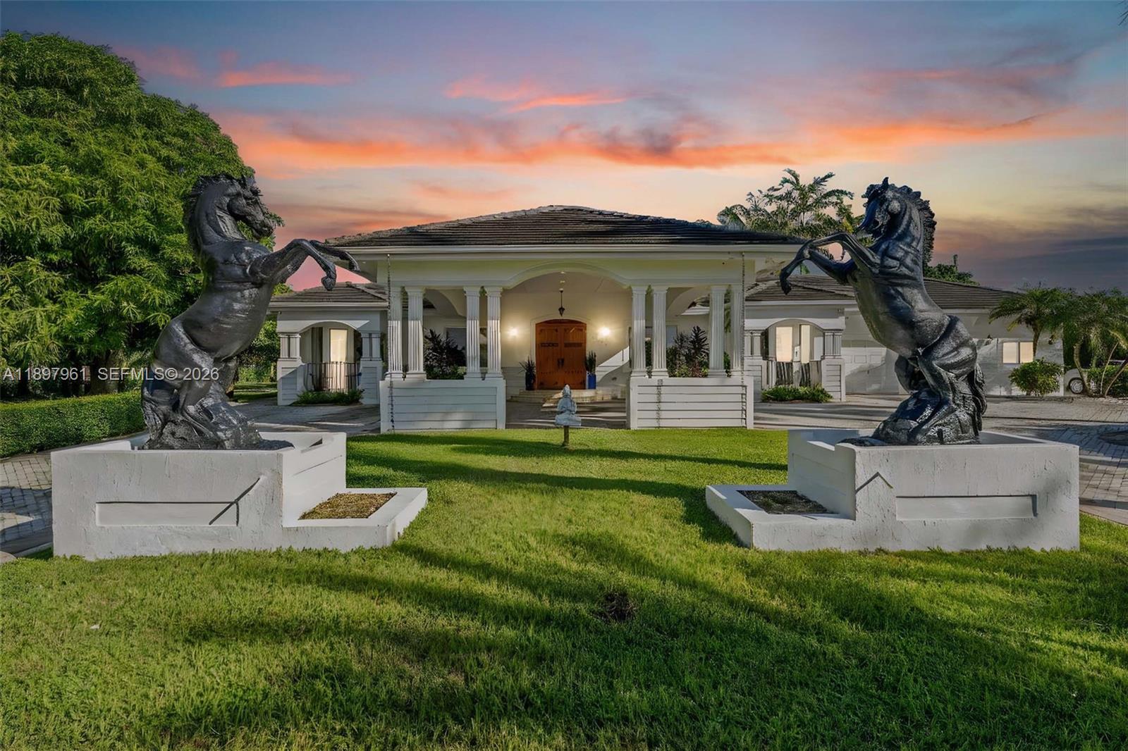 21331 Southwest 246th Street Homestead, FL 33031 - Photo 4 of 34 a front view of a house with a garden and plants