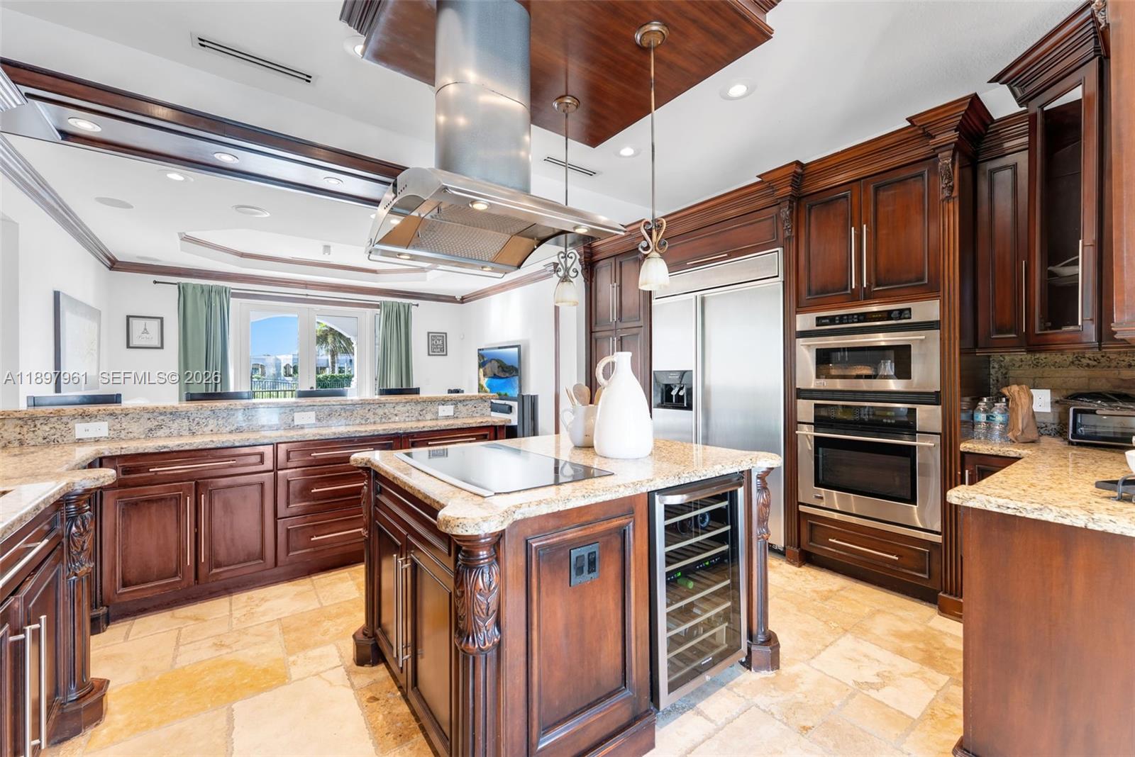 21331 Southwest 246th Street Homestead, FL 33031 - Photo 8 of 34 a kitchen with kitchen island granite countertop a sink appliances and cabinets